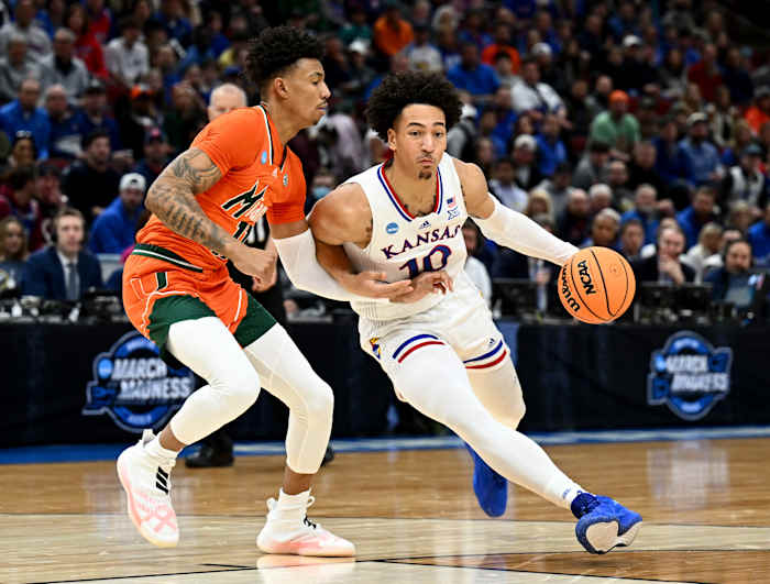 Mar 27, 2022; Chicago, IL, USA; Kansas Jayhawks forward Jalen Wilson (10) drives past Miami Hurricanes guard Jordan Miller (11) during the first half in the finals of the Midwest regional of the men's college basketball NCAA Tournament at United Center. Mandatory Credit: Jamie Sabau-USA TODAY Sports